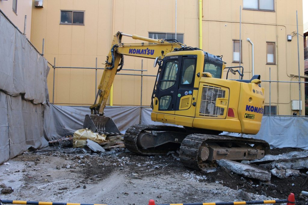 Yellow excavator on a construction site.